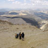 A group of hikers looks out over Sequoia National Park on the way down from Mount Langley.