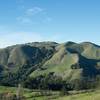 Numerous hills surround Mindego Hill. The hills are green in the winter, thanks to the rain storms that blow through.