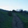 The trail, as it ascends the hill, is made up of crushed gravel and packed dirt.