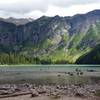 Avalanche Lake rests in the shadow of sheer, towering cliffs.