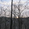 The sun rises over the forested hills surrounding the Sheltowee Trace.