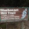 This is a trailhead sign for the Bluebonnet Hill Trail at Cedar Ridge Preserve.