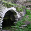 Hones Spring is shadowed by a beautiful stone bridge.