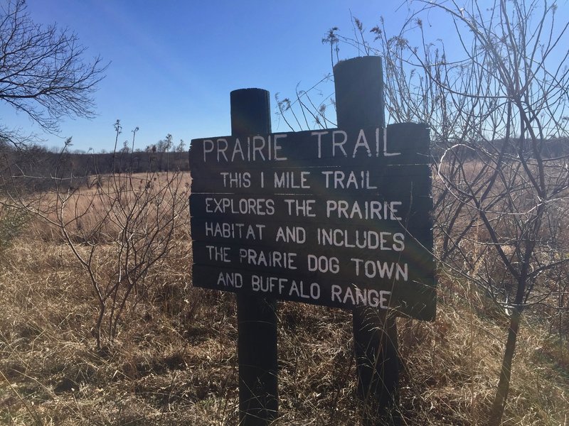 An informative sign marks the entrance to the Prairie Trail.