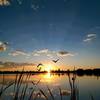 The sun rises over Denver at Sloan's Lake Park.