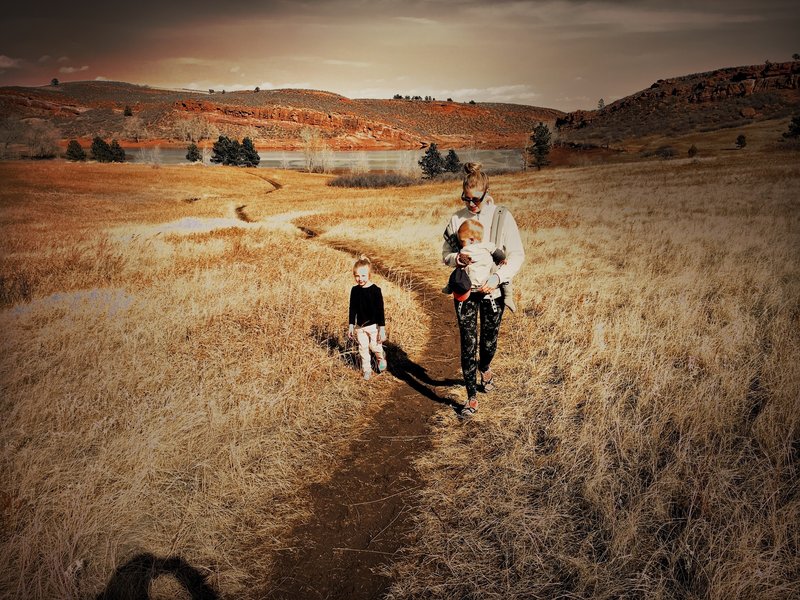 Our family hiking through the flat, open landscape of the trail.