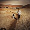 Our family hiking through the flat, open landscape of the trail.