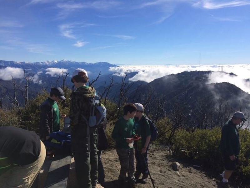 Our group checks out the view and the geocache at the top of San Gabriel Peak.