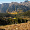 A lone hiker enjoys the solitude and fall colors on the south approach to Mount Elbert.