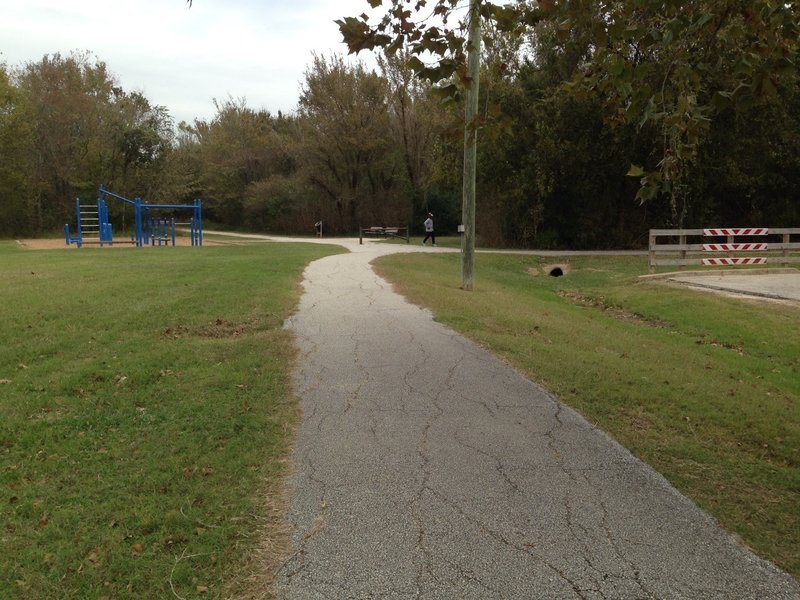 This is the west end of Cullen Park Bike and Hike Trail looking east at the trail leaving the parking lot.