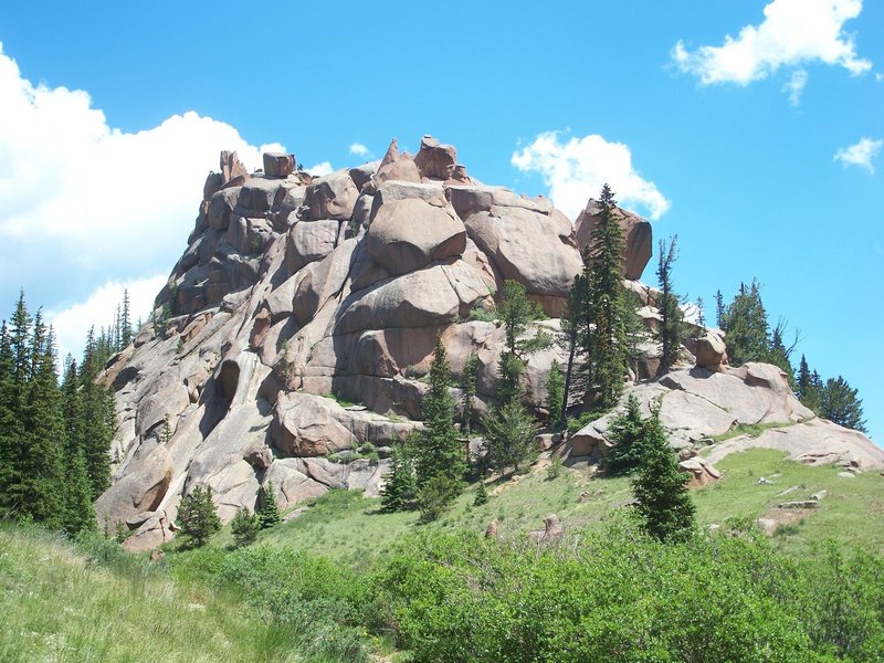 A towering rock formation stands guard near the stream crossing on The Crags Trail.