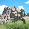 A towering rock formation stands guard near the stream crossing on The Crags Trail.