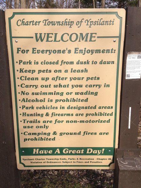 A trailhead sign details the rules at Hewen's Creek Park.