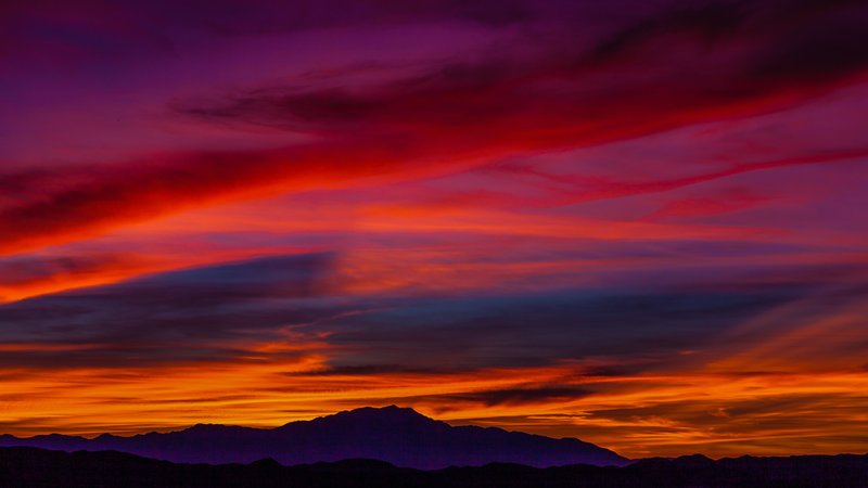 The clouds erupt in wonderful colors as we reach the summit of Mt. Ryan.