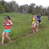 At mile 7.3, runners descend through the meadow below Rock Canyon Pass.