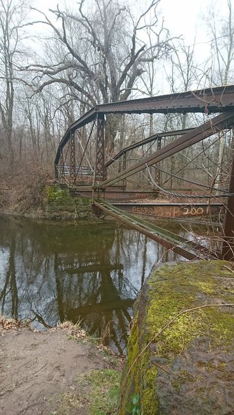 The remains of a former bridge over the Scantic River still stand near the trailhead.