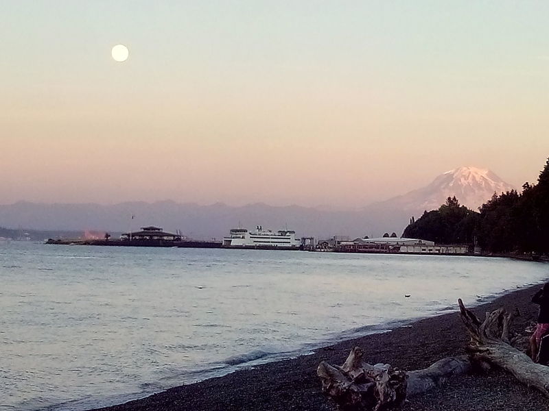 Mt. Rainier and the moon hide behind the Vashon Island Ferry and Tacoma Yacht Club.