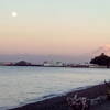 Mt. Rainier and the moon hide behind the Vashon Island Ferry and Tacoma Yacht Club.