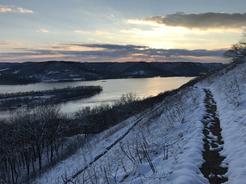 A winter sun sets over the goat prairie switchback on the Brady's Bluff Trail.