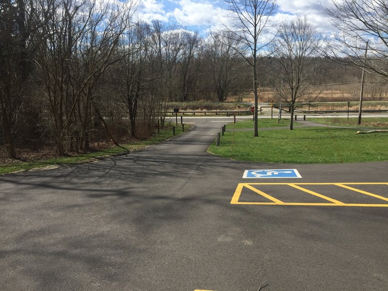 This is the parking lot of the Frazee House Trailhead. The entrance to the Sagamore Creek Loop Trail is on the left side of the driveway. Canal Road and the Ohio and Erie Canal Towpath Trail are visible in the background.