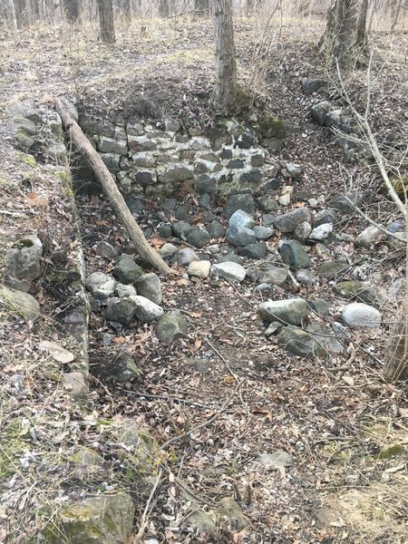 An old stone foundation is located beside the Red Oak Trail.