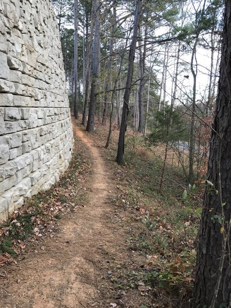 The Chesley Creek Loop travels beside the retaining wall for the Blue Ridge School athletic fields.