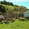 Old ranch machinery stands outside the historic ranch house and grounds.