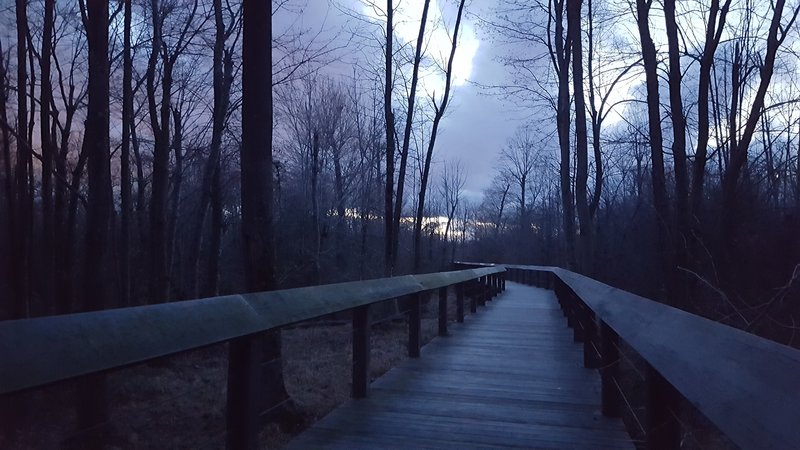 The sun sets over the bridge by the Mazza Grandmarc Apartments.