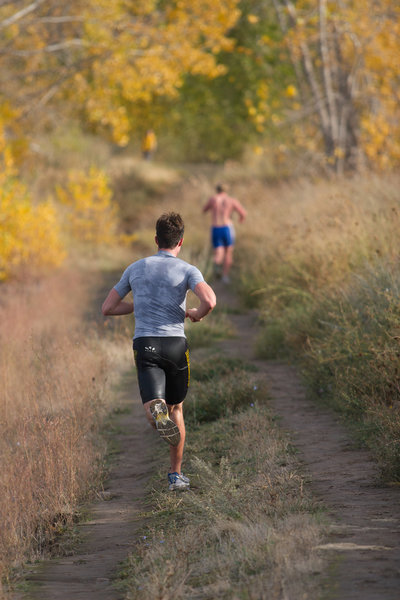 Runners from Western Washington University compete in a triathlon along the Meadowlark Trail in Bennington Lake, WA.