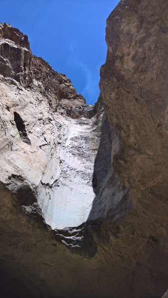 Lower Burro Mesa Pour-off towers overhead at the end of the trail.