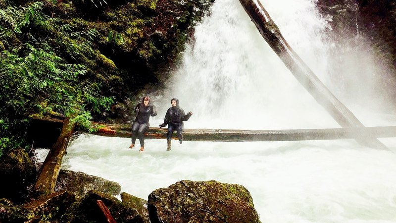 Our group gets soaked as they sit on the infamous fallen tree.