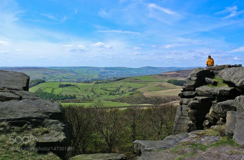 A hiker enjoys the view along the Strange Edge.