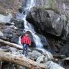 A fellow hiker enjoys the chilly spray from Apple Orchard Falls.