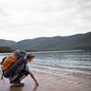 A hiker enjoys the waters of Sealers Cove.