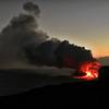 An epic sunset bolsters the view of lava flowing into the ocean from the edge of the flow in April 2017.