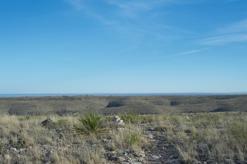 Cairns mark the trail, providing guidance along the primitive surface.