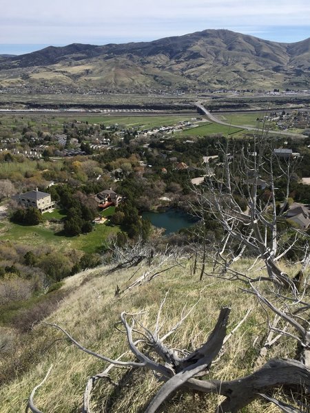 In the first mile of the trail, as the hillside drops off below, the view to the northeast shows the new South Town Connector and the mountains beyond.