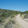 A view looking back to the visitor center; at this point, the trail goes from being paved to being gravel as it is part of the Old Guano Road.