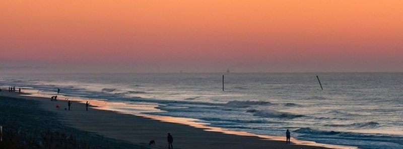 Looking north in Surf City, NC at the old pilings from the lost Barnacle Bills Pier.