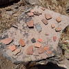 Pottery sherds are abundant around the dwelling.