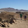 Two hikers ascend the Elephant Knees ridge.