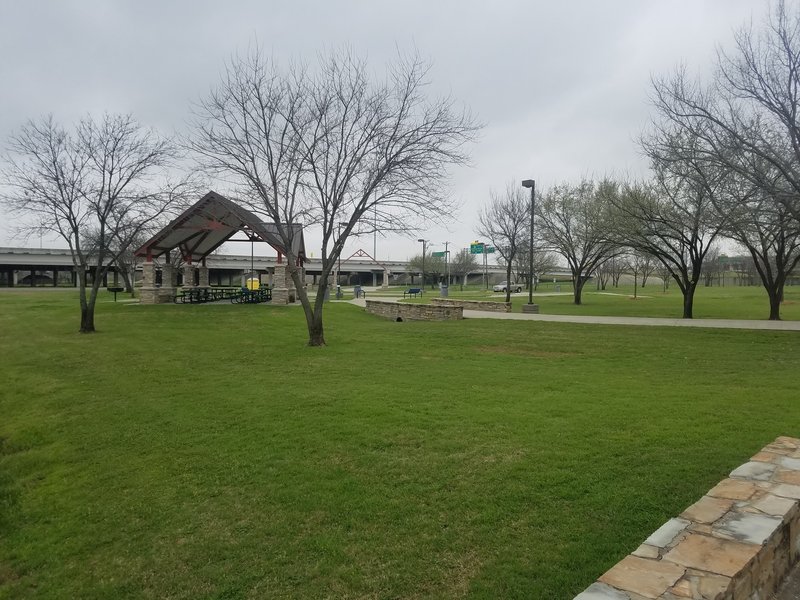 Plenty of green grass fills the space between the trail, parking area, and one of the small pavilions in Richardson Grove Park.