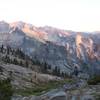 A hiker photographs the sunset on the ridge.