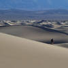 An early morning hiker sinks her soles into the Mesquite Sand Dunes.