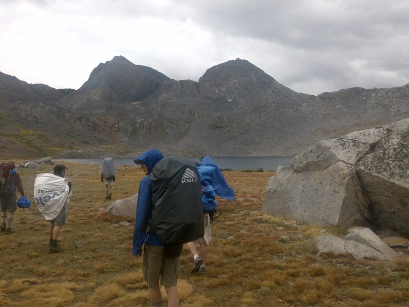 A rain-filled stretch of clouds looms over Martha Lake and the Goddard Canyon Trail.