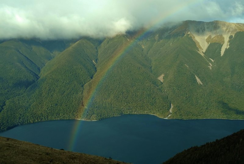 A rainbow forms over Lake Rotoiti on a snow-showery day high on Paddy's Track.