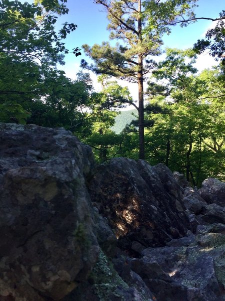 This boulder outcrop offers a peek at Rich Mountain.