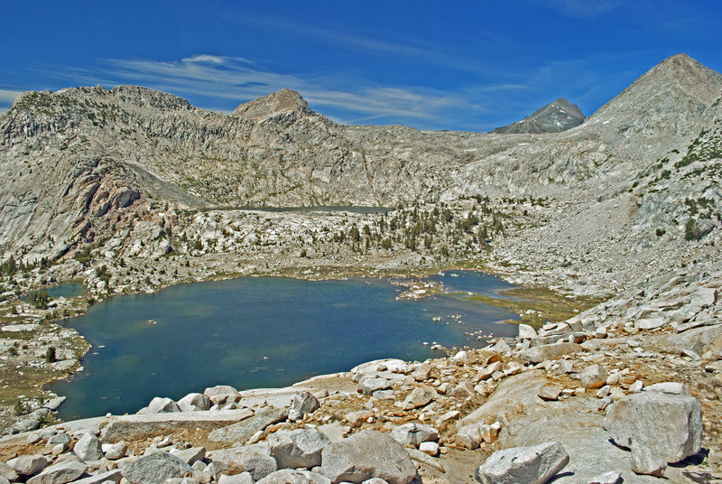 Bighorn Lake shines with Ambition Lake barely visible above it. Mt. Goddard is the dark peak over the ridge. Valor Pass is on the ridge directly in front of it, with Mt. Reinstein on the extreme right.