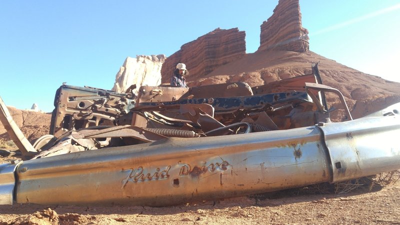 A burnt out car still sits at the Tomsich Butte Trailhead.