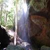 A waterfall trickles down the rocks past Hawk Creek Suspension Bridge.